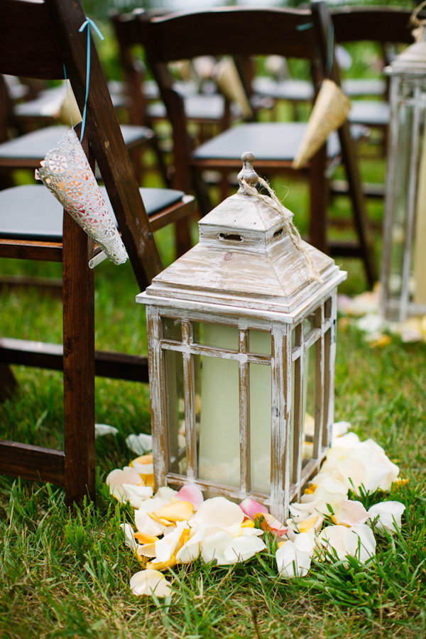 Vintage style lanterns with candles and flower petals as aisle markers - photo by Dan Stewart Photography